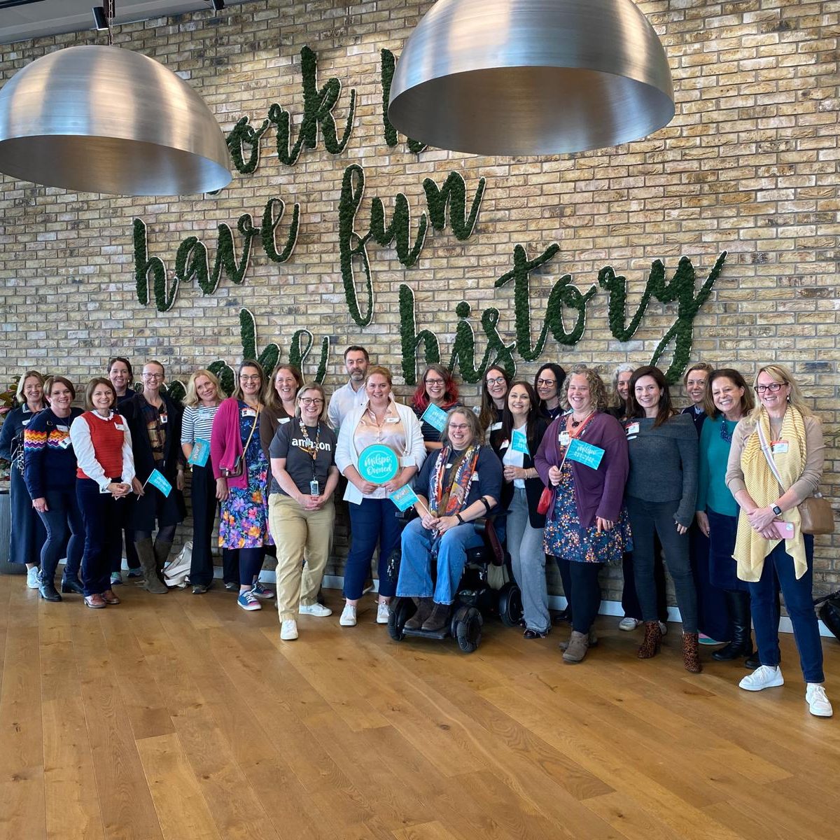 The Milspo Members The Milspo gang at Amazon HQ in London, UK. All stood in front of a sign that reads 'Work hard, have fun, make history